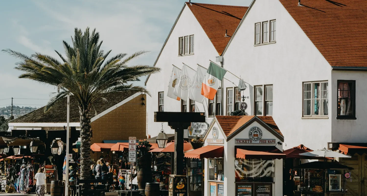 Shops, pedestrians, and palm trees along a market street in Old Town San Diego