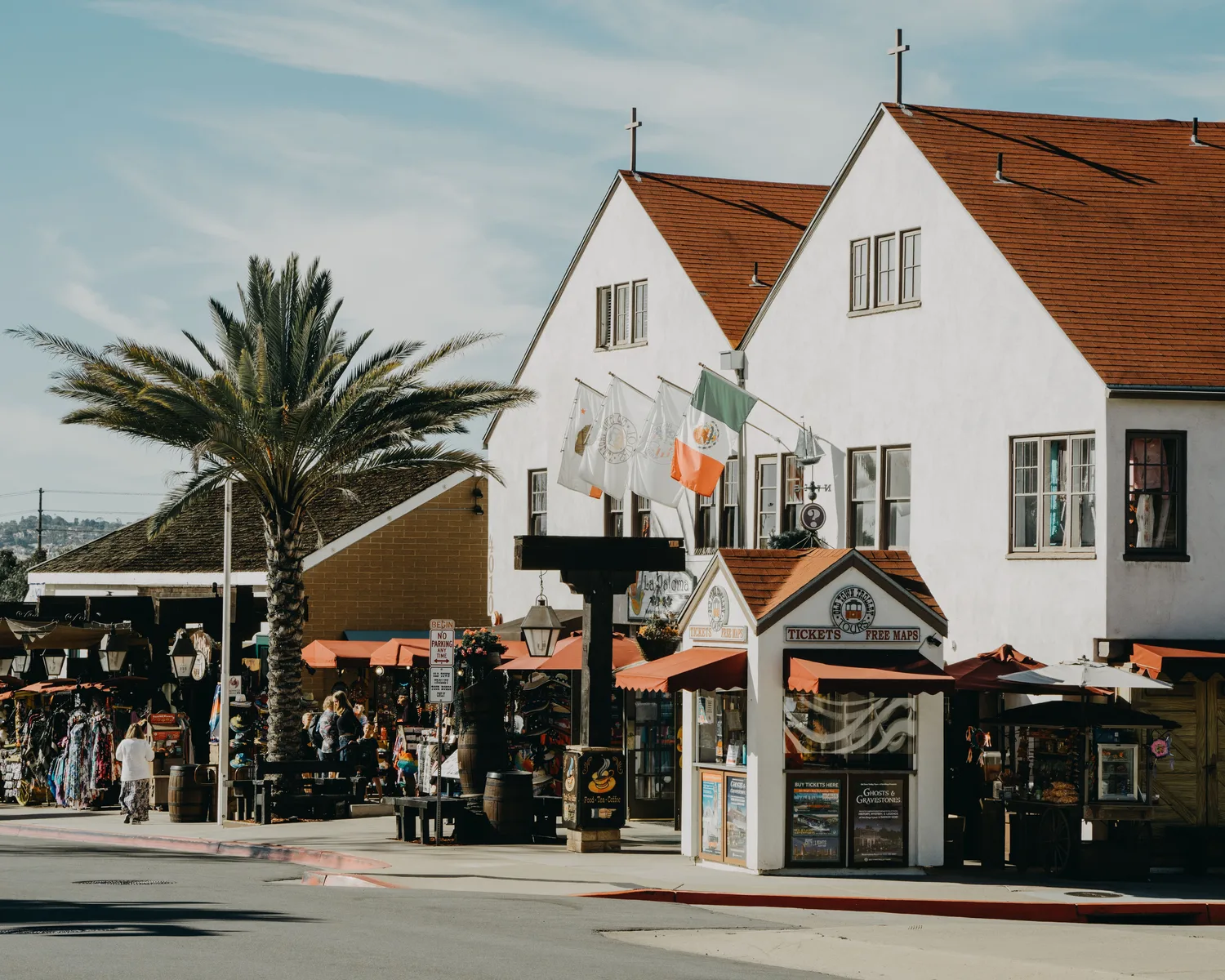 Shops, pedestrians, and palm trees along a market street in Old Town San Diego