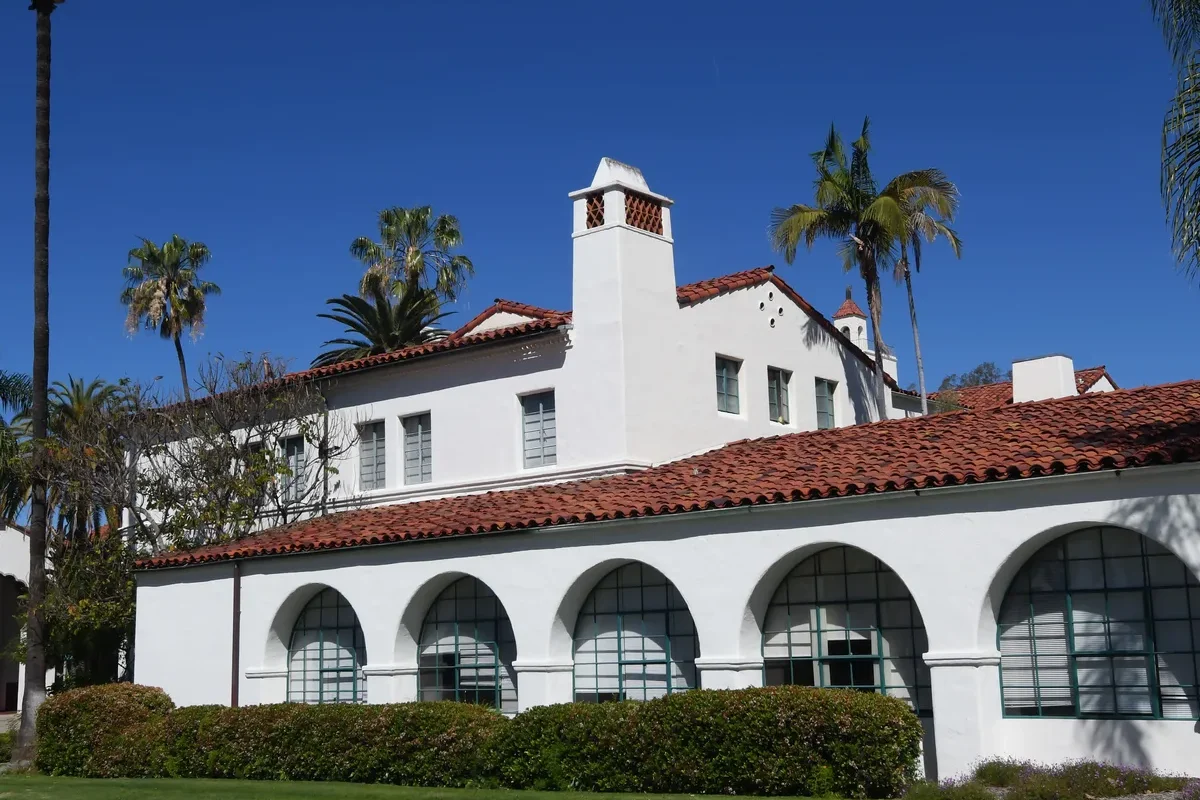 White stucco architecture with red tile and palm trees in San Diego